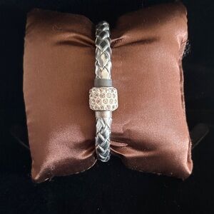 Trendy silver metallic bracelet with embellishments at the clasp
